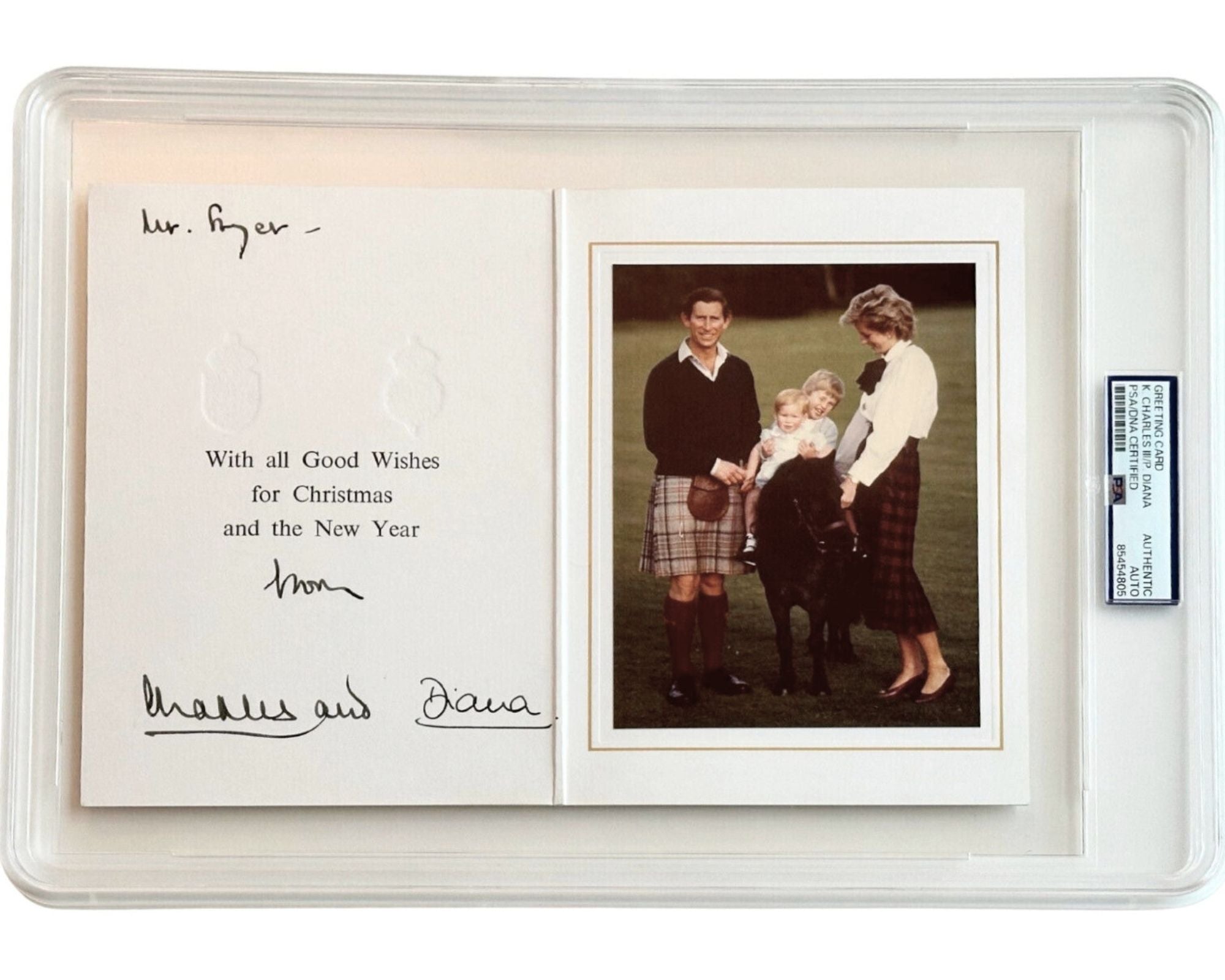 Autographed Christmas card with Princess Diana and King Charles, with photo inside a PSA case.